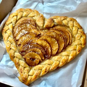 apple pie with braided crust in a heart shape