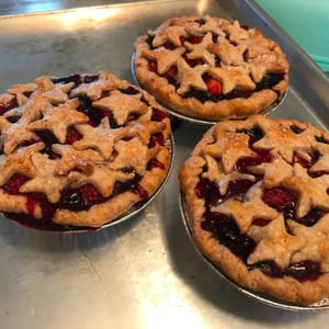 mixed berry mini pies with star shaped top crust